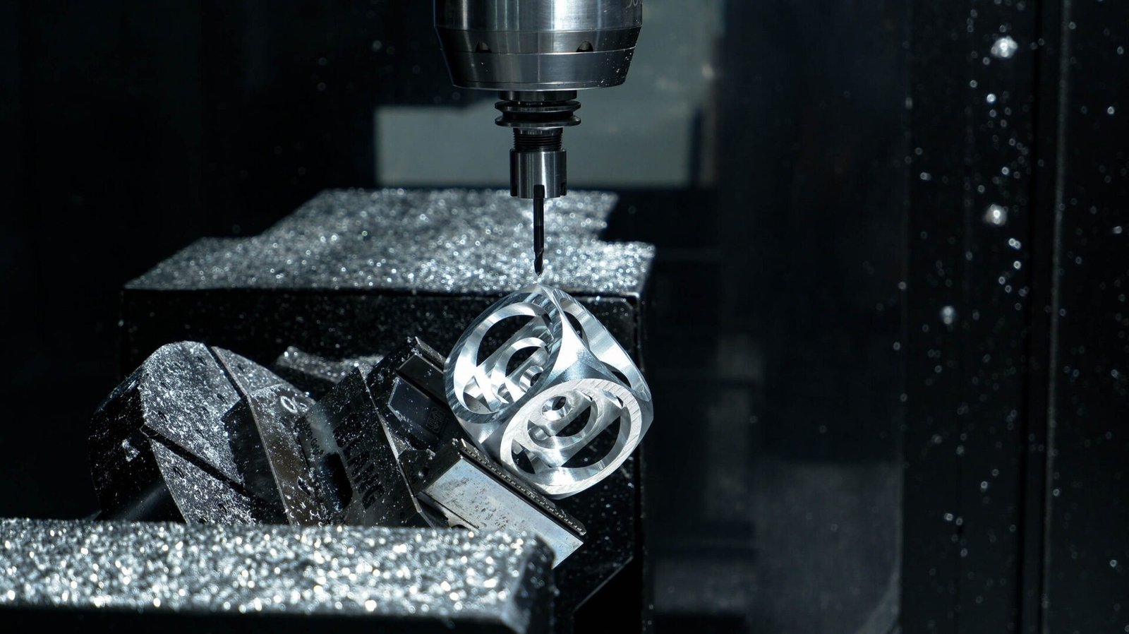CNC Machining Tolerances Explained: ISO 2768-mK, H7/g6 Fits and Practical Tables 7 Five-axis CNC machining center producing precision metal components
