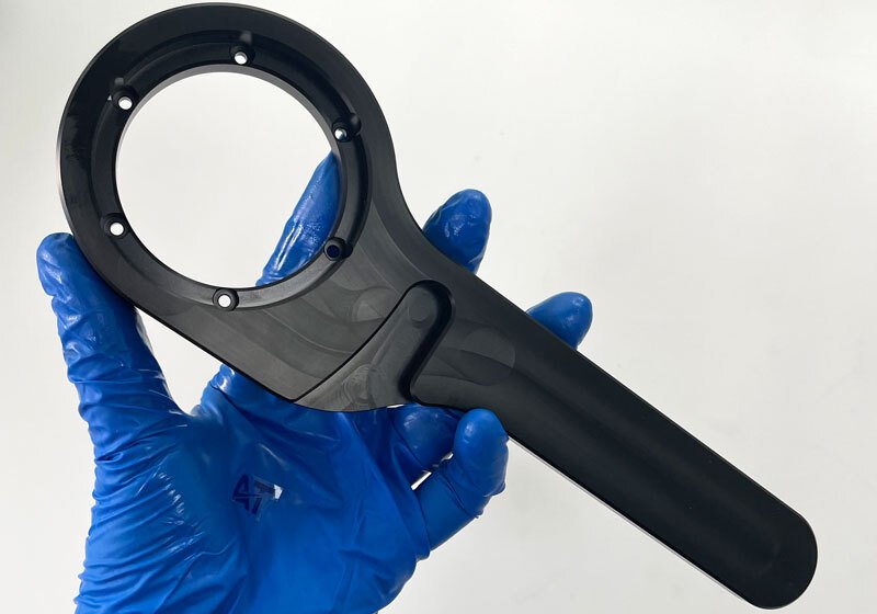 Black ABS CNC machined plastic part with circular mounting features