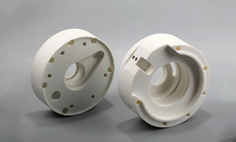 CNC machined plastic part with circular features and mounting holes